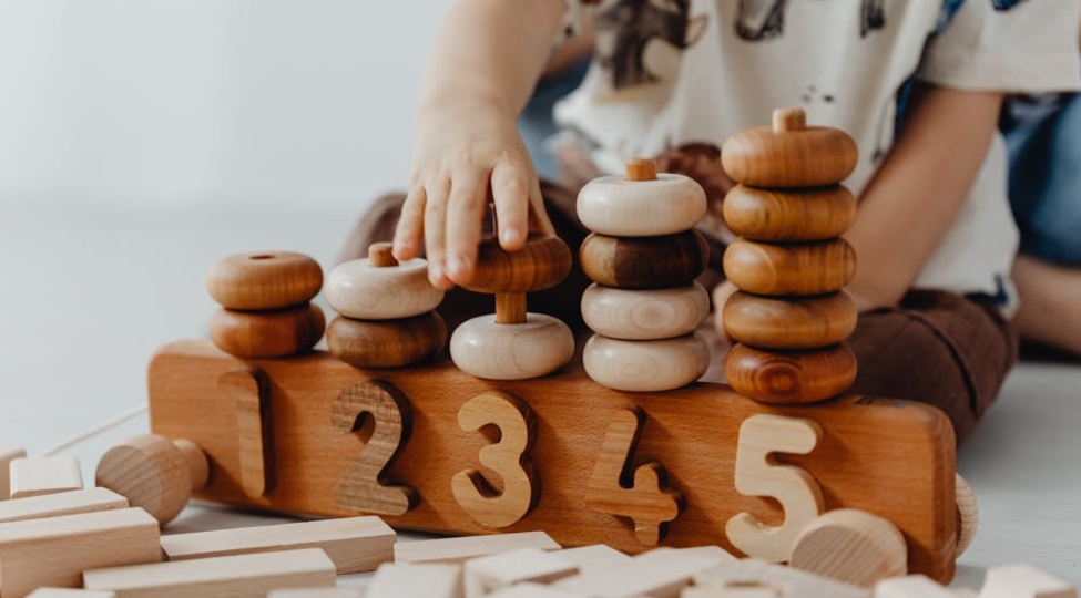 a boy playing with numbered rings
